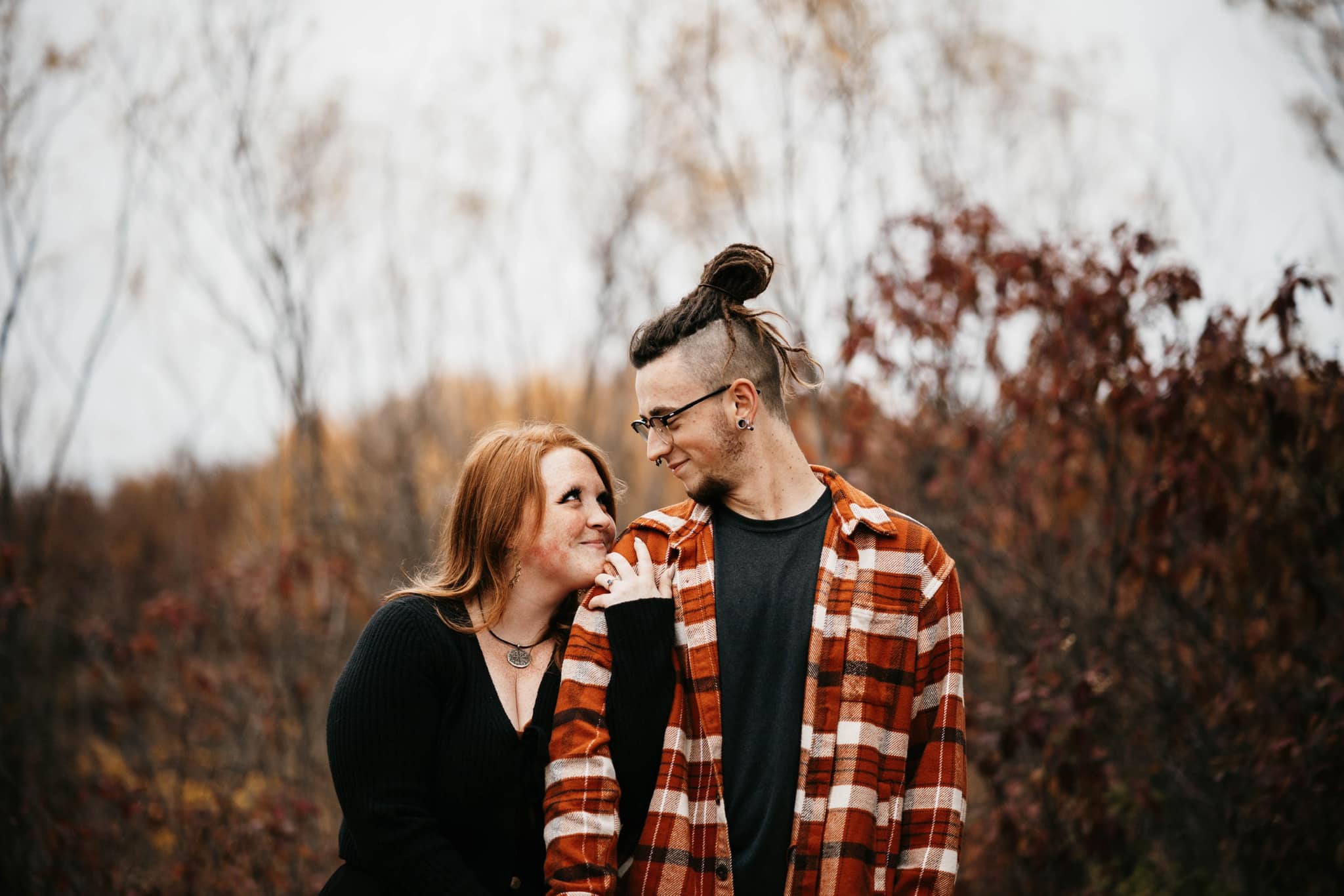Autumn and Grayson standing together in an autumn field