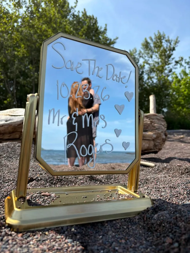 Autumn and Grayson reflected in a mirror with their wedding date
